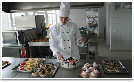 A chef preparing desserts in a commercial kitchen